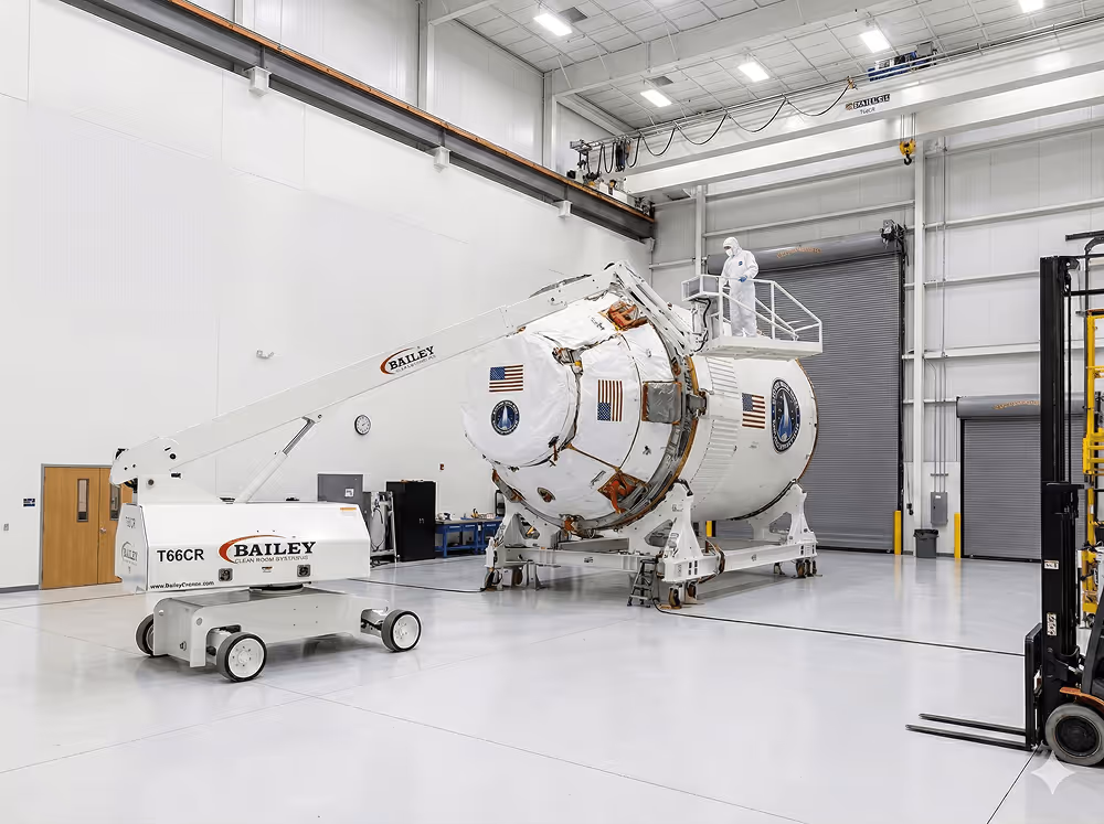 Bailey lift maneuvering an aerospace fuselage section in a clean room